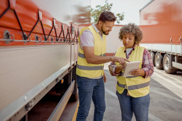 istock Logistics Manager Controlling Truck Driver Schedule With Digital Tablet 2165069567
