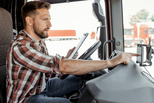 istock Male Truck Driver Checking Shipment List 2165069573