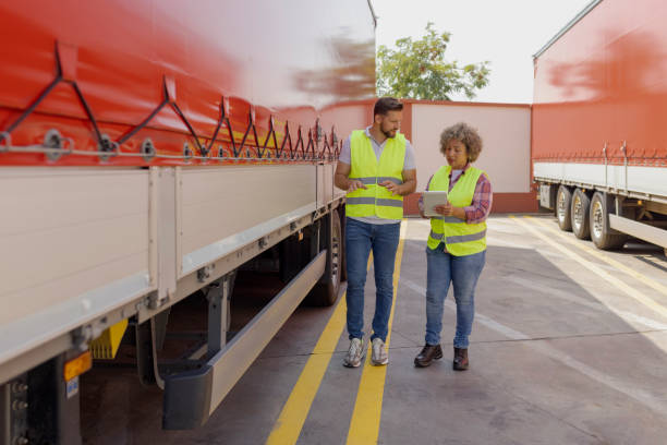 istock Logistics Manager Controlling Truck Driver Schedule With Digital Tablet 2165069626
