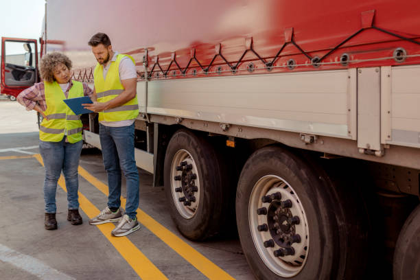 istock Truck Drivers Talk and Perform a Technical Inspection 2165069705