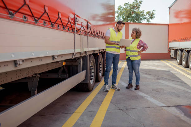istock Logistics Manager Controlling Truck Driver Schedule With Laptop 2165069804