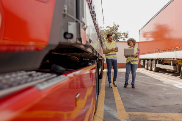 istock Logistics Manager Controlling Truck Driver Schedule With Laptop 2165069815