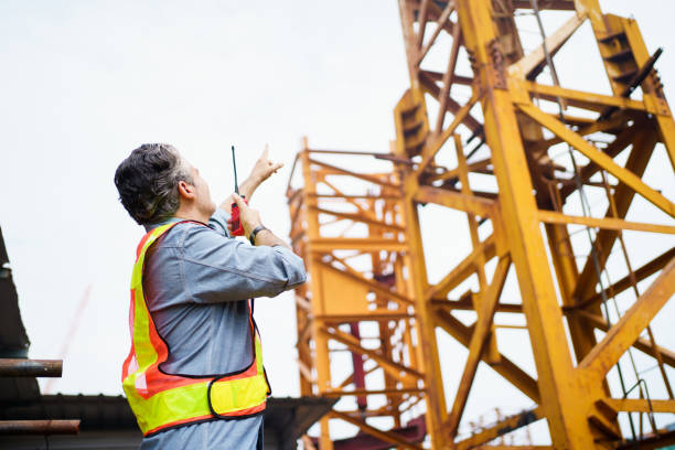 istock Careless worker at construction site without wearing helmet. 2165071489
