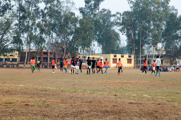 Rohtak, Haryana, India – Feb 12, 2018: Local teams playing football game together in playground.