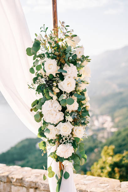 istock Wedding arch stand decorated with white flowers and fabric 2165078830