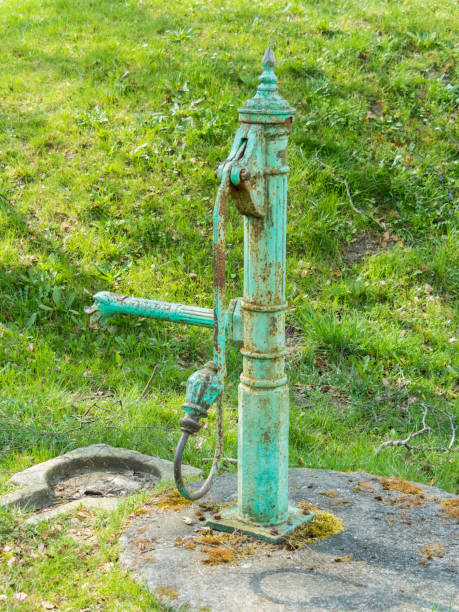 istock Rustic Water Well by the Wooden House 2165082255