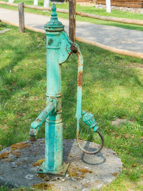 istock Rustic Water Well by the Wooden House 2165082263