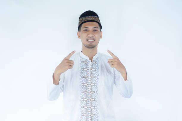 istock Moslem Asian man pointing to his mouth with happy expression 2165082982