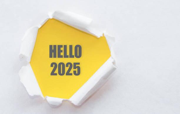 istock A yellow note with HELLO 2025 peeks through torn white paper, symbolizing a fresh start and business opportunities for the upcoming year. 2165088438