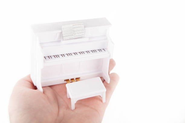 image of miniature piano hand white background