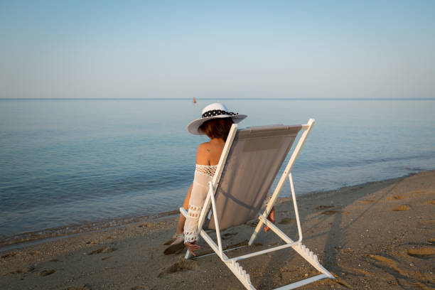 A woman on the beach enjoying her time in the morning hours