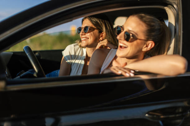 istock Two women in a car on a road trip 2165100706