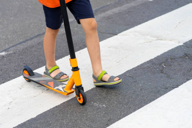 istock A child on a scooter walks along a pedestrian crossing 2165102927
