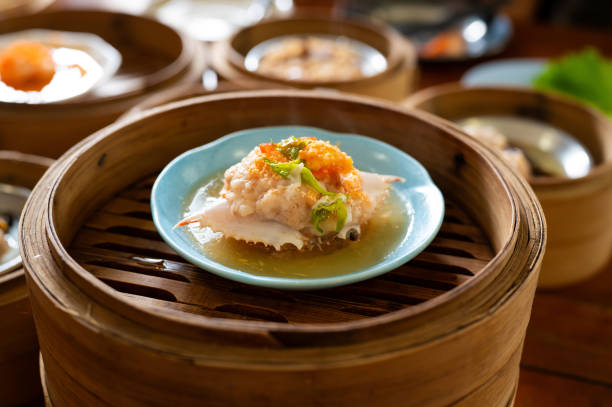 Traditional Chinese crab shell dim sum served in bamboo steamer baskets at local Chinese restaurant, Kuala Lumpur Malaysia.