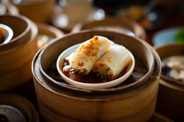 Delicious traditional dim sum Chinese Chee Cheong Fun served in bamboo steamer basket at local Chinese restaurant, Kuala Lumpur Malaysia.