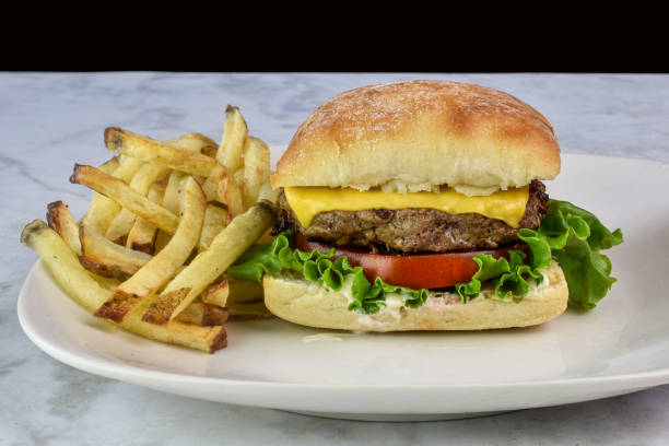 istock cheese burger  on a brioche bun served with fries 2165107008