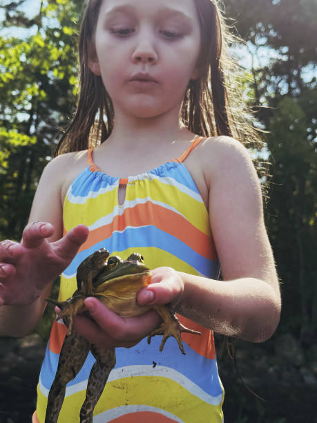 istock Girl Holds Frogs 2165108480