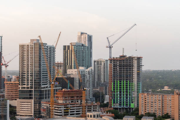 Austin, Texas, USA - July 27, 2023 - Tower Cranes and skyscrapers under construction on the downtown Austin Skyline at Sunrise