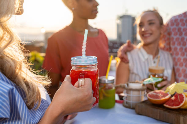 istock Young people drinking colorful drinks and having fun on a rooftop 2165111117