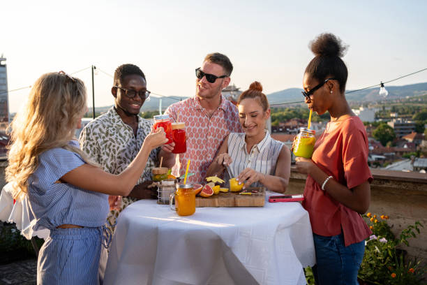 istock Young group of friends toasting with fruit mocktails at a party 2165111121