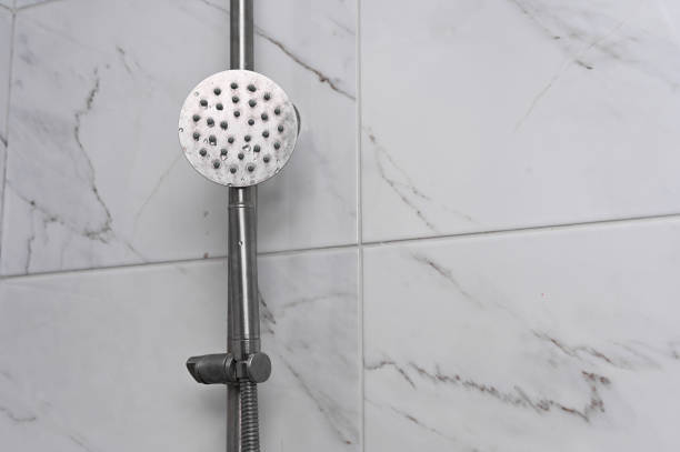 shower head against the background of ceramic tiles in the bathroom. Close-up