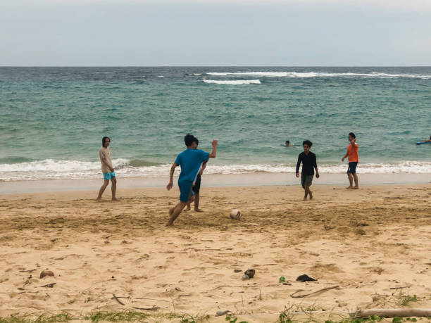 21 March 2025, Da Nang - Vietnam. A young woman plays volleyball on the beach in Da Nang, enjoying the city’s long coastline. Beaches like My Khe and My An are popular favorites for both relaxation and recreational activities.