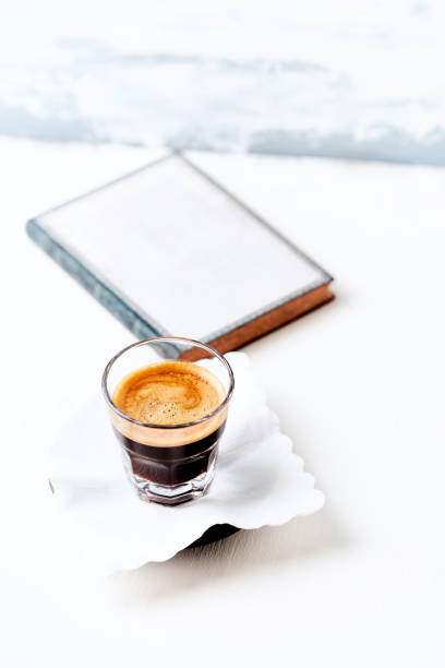 istock Coffee in glass cup on bright wooden background. Copy space. 2165117990