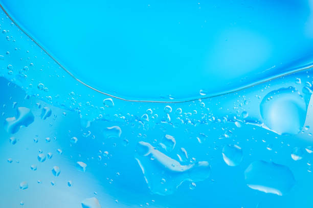 istock Close-up of blue liquid with bubbles and droplets, creating an abstract, refreshing, and clean appearance. 2165118020