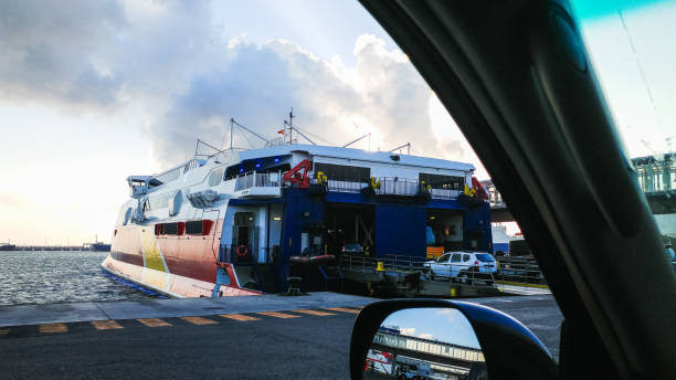 A 4x4 SUV stands in line waiting to board a ferry (RO-RO ) bound for Morocco from Spain. In the picture you can see how another vehicle boards the ship.