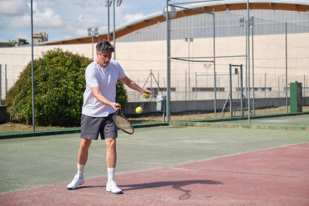 istock Focused senior man playing tennis on a sunny day 2165122984