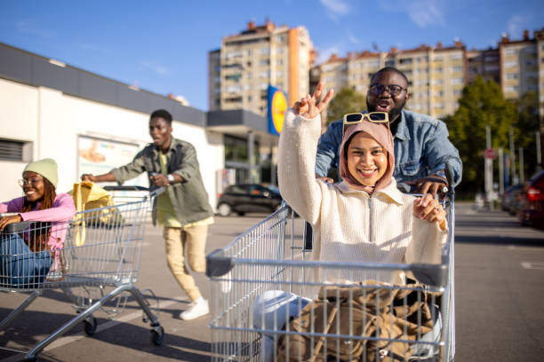 istock Couples racing with shopping carts 2165123179