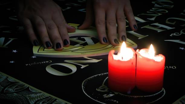 istock Witchcraft Spiritual Game Ouija Board and Fire 2165124594