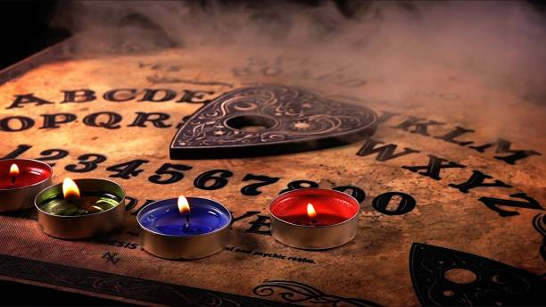 istock Witchcraft Spiritual Game Ouija Board and Fire 2165124807