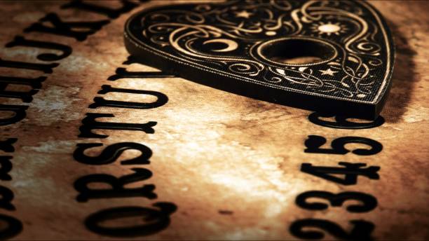 istock Witchcraft Spiritual Game Ouija Board and Fire 2165124872
