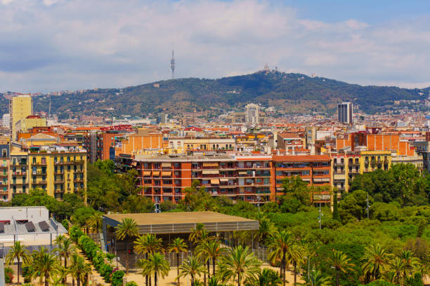 Barcelona's architectural diversity and mountainous backdrop. Lush greenery and residential buildings blend into the city’s vibrant atmosphere.