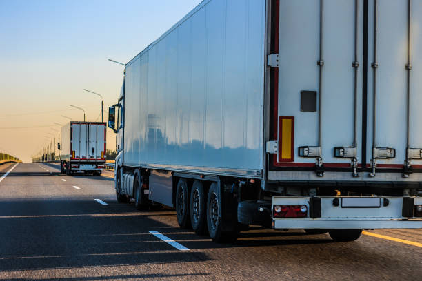 istock Trucks moving along a country highway 2165128311