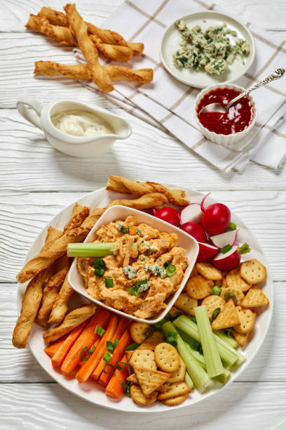 istock buffalo chicken dip with veggie and bread sticks 2165129552