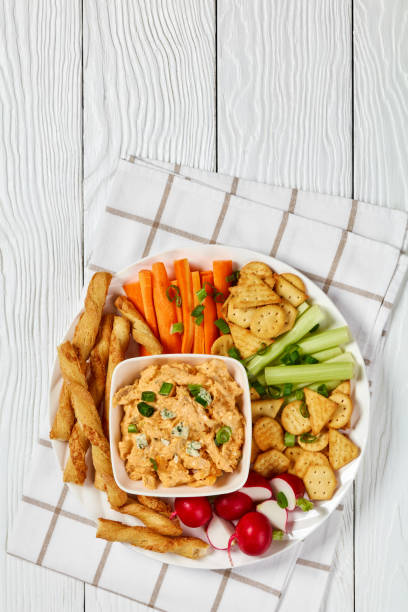 istock buffalo chicken dip with veggie and bread sticks 2165129573