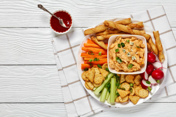 istock buffalo chicken dip with veggie and bread sticks 2165129598