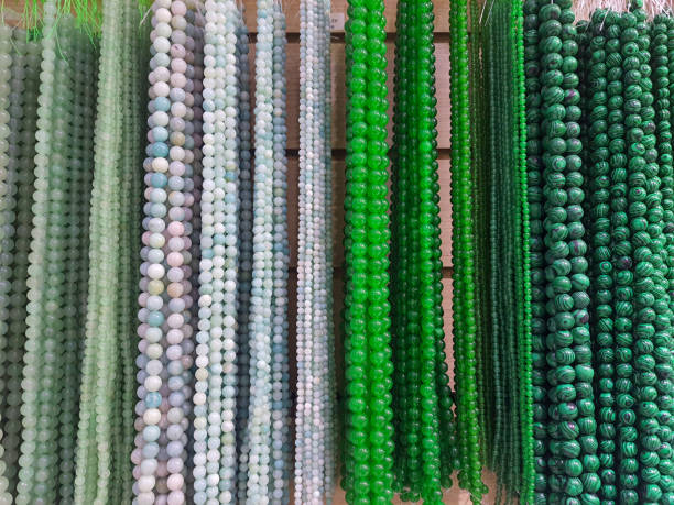 istock Semi-precious stone beads hanging in a row. 2165130398