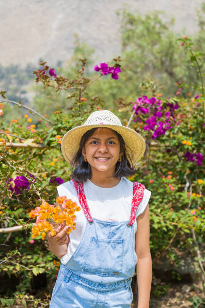 istock A young girl wearing a straw hat 2165130632