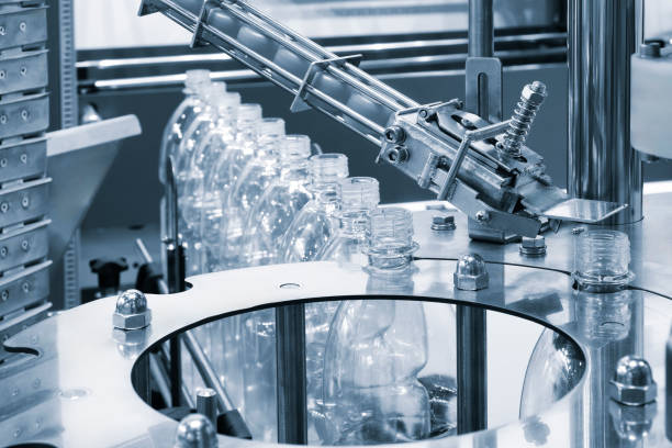 istock A machine is filling bottles with liquid 2165130698