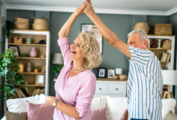 istock Happy senior couple dancing at home 2165131255
