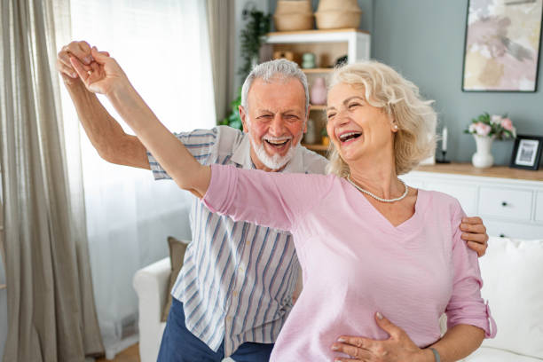 istock Senior couple dancing together at home 2165131434
