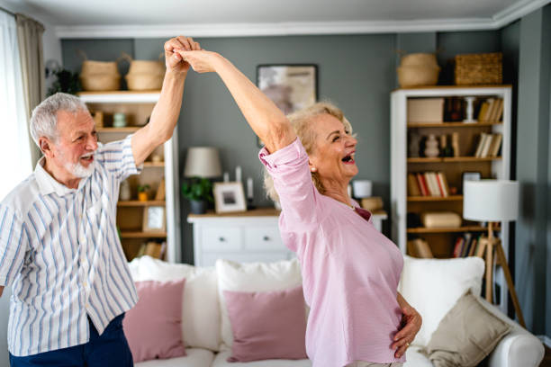 istock Senior couple dancing together at home 2165131960