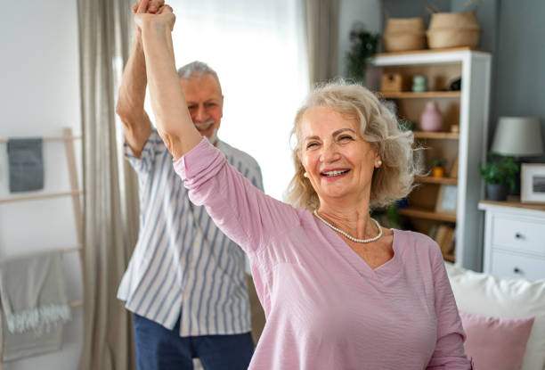 istock Senior couple dancing together at home 2165131977