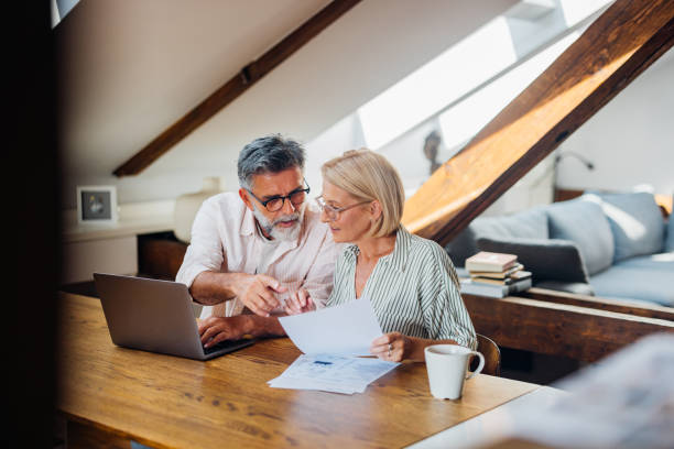 Senior Couple Working on Documents at Home Office Desk
