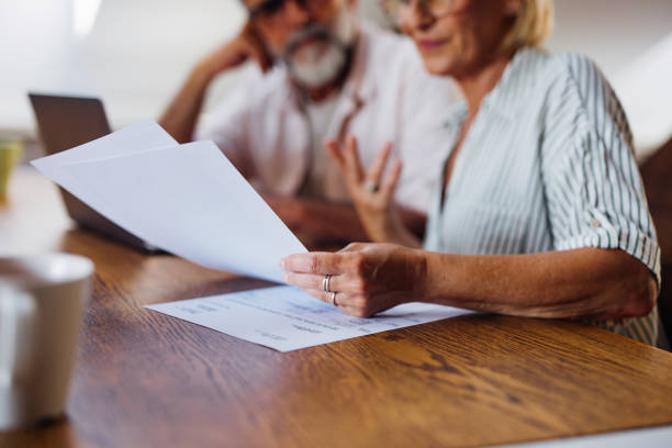 Senior Couple Reviewing Documents at Home Together