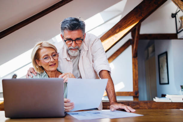 istock Senior Couple Working Together In Their Home Office 2165132891