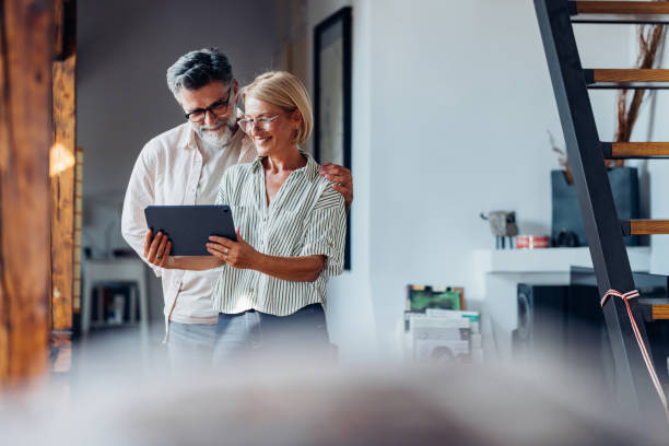 Happy Senior Couple Using Digital Tablet at Home Together